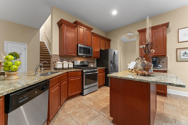 14047 Pikesdale, San Antonio, TX 78253 - kitchen with tasteful backsplash, light stone counters, stainless steel appliances, arched walkways, and a sink