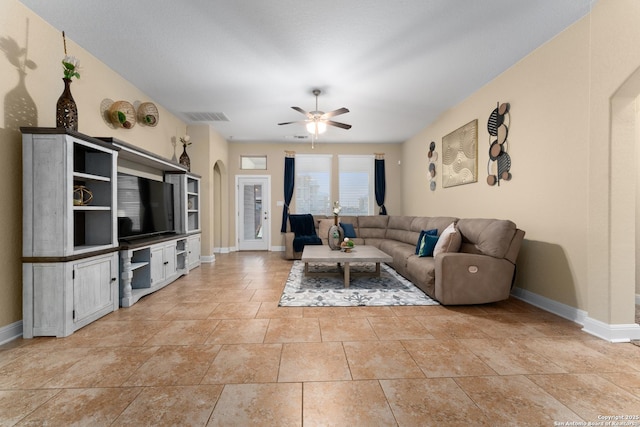 14047 Pikesdale, San Antonio, TX 78253 - living area featuring arched walkways, baseboards, a ceiling fan, and visible vents