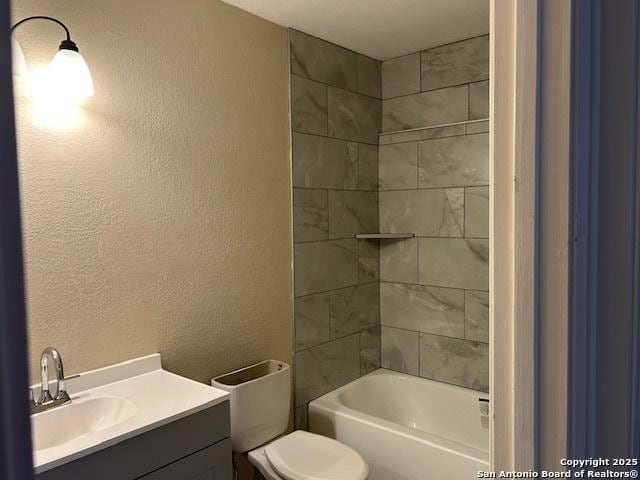 7834 Sun Frst, San Antonio, TX 78239 - full bathroom with a textured wall,  shower combination, vanity, and toilet