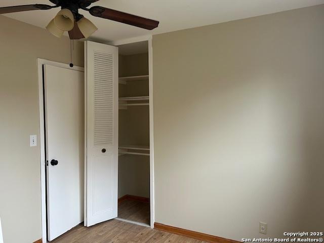 7834 Sun Frst, San Antonio, TX 78239 - unfurnished bedroom featuring light wood-style floors, a closet, baseboards, and a ceiling fan