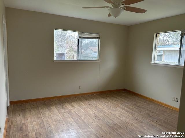 7834 Sun Frst, San Antonio, TX 78239 - unfurnished room featuring wood finished floors, baseboards, and a ceiling fan