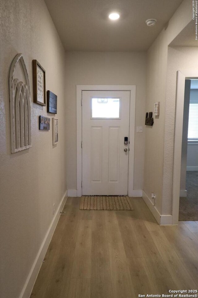 5544 Jewel, San Antonio, TX 78266 - doorway to outside featuring baseboards and light wood-style floors