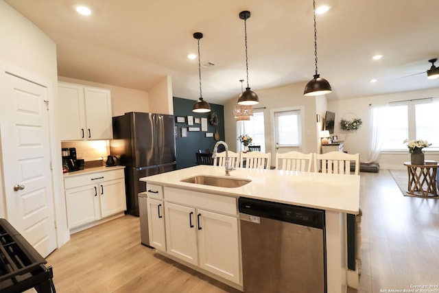 5544 Jewel, San Antonio, TX 78266 - kitchen featuring light wood-type flooring, freestanding refrigerator, a center island with sink, stainless steel dishwasher, and a sink