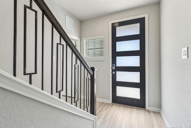 18107 Ansley, San Antonio, TX 78247 - foyer entrance featuring wood finished floors, baseboards, visible vents, and stairway
