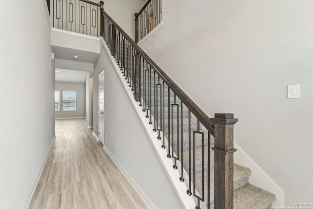 18107 Ansley, San Antonio, TX 78247 - stairway with baseboards, a towering ceiling, and wood finished floors