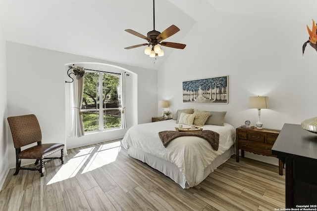 bedroom with high vaulted ceiling, light wood-type flooring, and ceiling fan