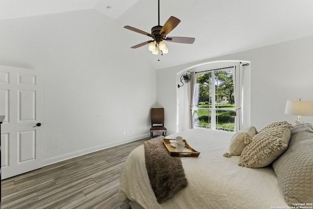 bedroom featuring high vaulted ceiling, ceiling fan, baseboards, and wood finished floors
