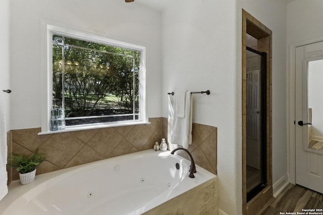full bathroom featuring a jetted tub and a stall shower