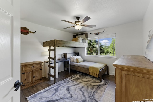 bedroom featuring baseboards, a ceiling fan, and wood finished floors