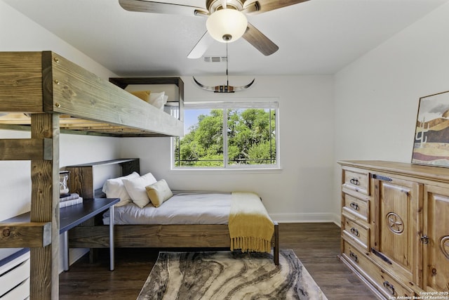 bedroom featuring visible vents, baseboards, ceiling fan, and dark wood finished floors