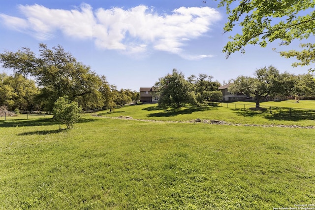 view of yard with a rural view and fence