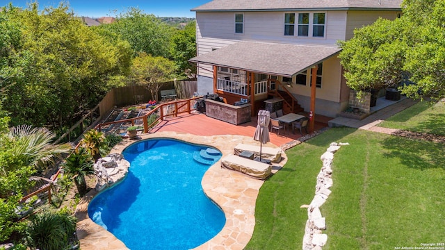 view of pool featuring a fenced in pool, a patio area, a fenced backyard, a wooden deck, and a yard
