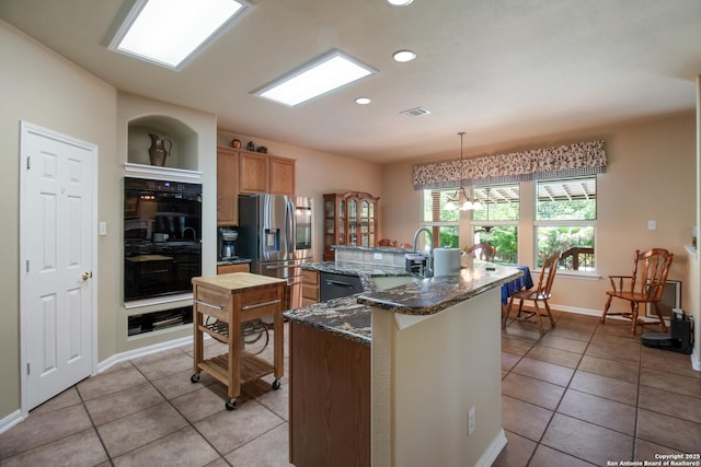 kitchen with visible vents, black appliances, light tile patterned flooring, and recessed lighting