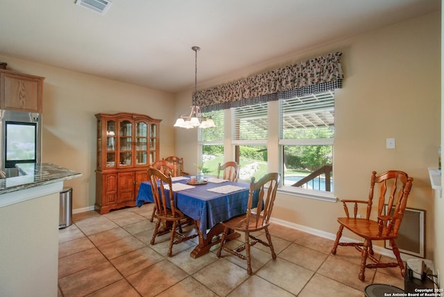 dining space with visible vents, light tile patterned floors, baseboards, and an inviting chandelier