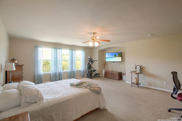 bedroom featuring ceiling fan, baseboards, and carpet