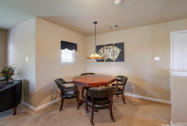 carpeted dining room featuring visible vents and baseboards