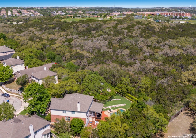 bird's eye view with a wooded view and a residential view