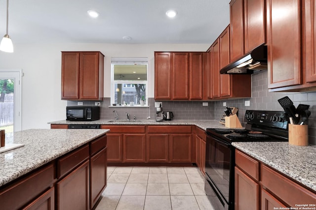 26019 Florencia Villa, Boerne, TX 78015 - kitchen with under cabinet range hood, decorative backsplash, black appliances, and a wealth of natural light