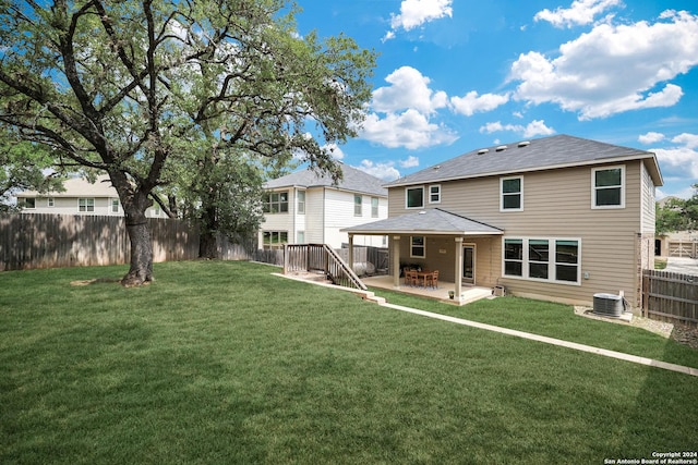 26019 Florencia Villa, Boerne, TX 78015 - back of property with a yard, a fenced backyard, central AC unit, and a patio area