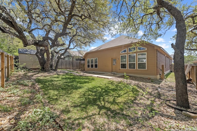 7635 Mission Smt, Boerne, TX 78015 - rear view of house featuring a fenced backyard, an outdoor structure, a lawn, and a storage unit