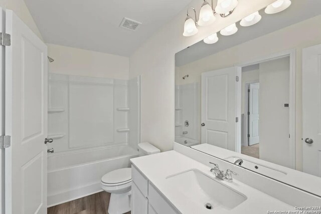3219 Tumbleweed Hl, San Antonio, TX 78222 - bathroom featuring visible vents, toilet,  shower combination, vanity, and wood finished floors