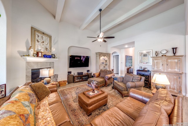22522 Estacado, San Antonio, TX 78261 - living room with arched walkways, ceiling fan, a fireplace, beamed ceiling, and high vaulted ceiling