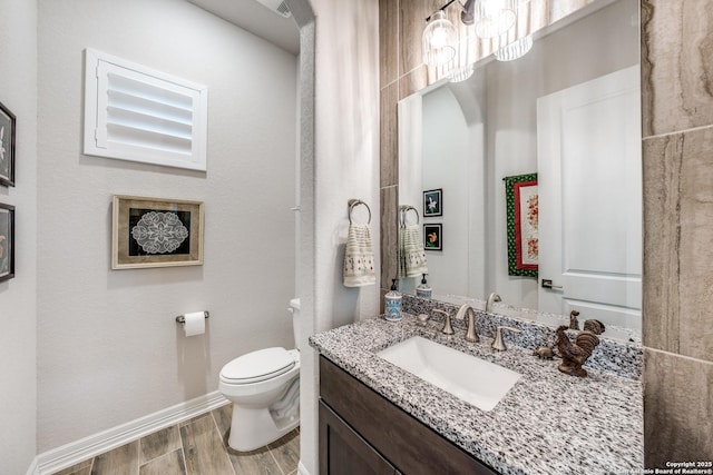22522 Estacado, San Antonio, TX 78261 - half bath featuring toilet, wood finished floors, vanity, and baseboards