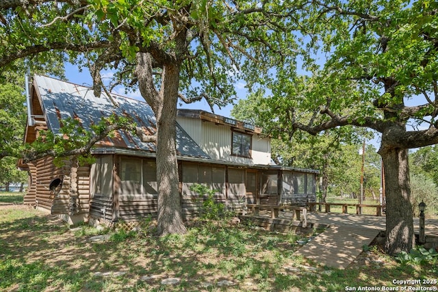 463 Woodland, Fredericksburg, TX 78624 - back of property featuring log siding, a sunroom, and metal roof