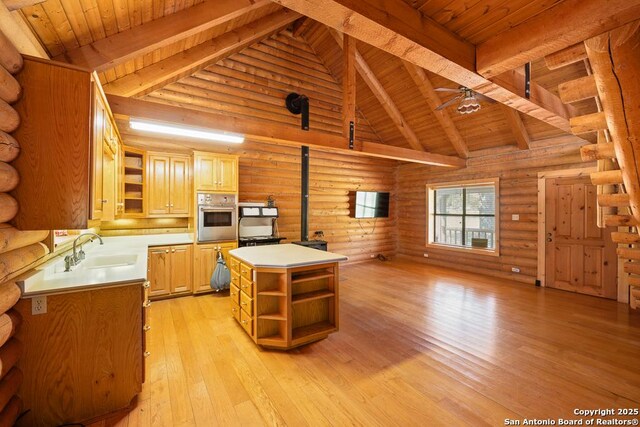 463 Woodland, Fredericksburg, TX 78624 - kitchen featuring open shelves, beamed ceiling, oven, wooden ceiling, and a sink