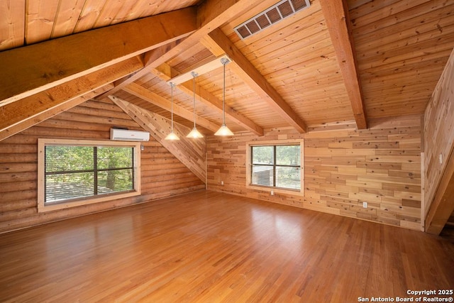 463 Woodland, Fredericksburg, TX 78624 - additional living space featuring a wall unit AC, visible vents, wood finished floors, wooden ceiling, and lofted ceiling with beams