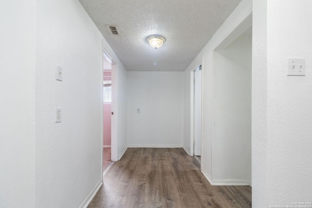 123 Haby Dr, San Antonio, TX 78212 - corridor with visible vents, a textured ceiling, baseboards, and wood finished floors