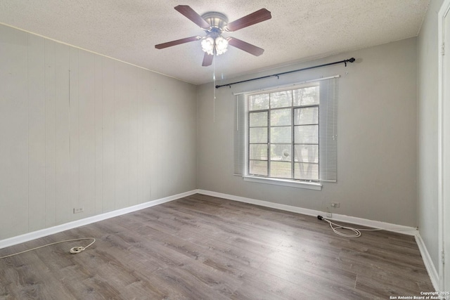 123 Haby Dr, San Antonio, TX 78212 - unfurnished room featuring a textured ceiling, wood finished floors, ceiling fan, and baseboards