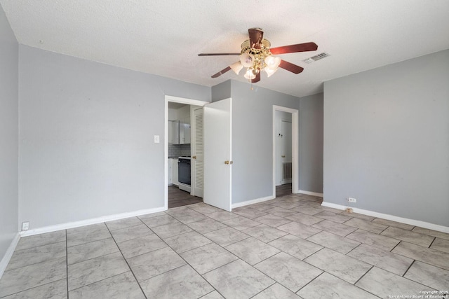 123 Haby Dr, San Antonio, TX 78212 - unfurnished room featuring a textured ceiling, ceiling fan, baseboards, and visible vents