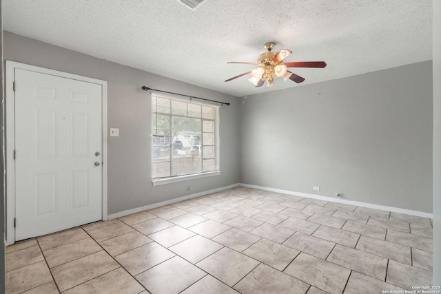 123 Haby Dr, San Antonio, TX 78212 - tiled empty room featuring a textured ceiling, ceiling fan, and baseboards