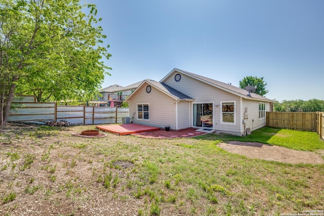 6611 Millrock, Live Oak, TX 78233 - rear view of property with an outdoor fire pit, a fenced backyard, a wooden deck, and a lawn