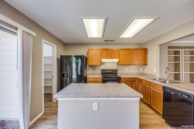 6611 Millrock, Live Oak, TX 78233 - kitchen with light wood-type flooring, black appliances, under cabinet range hood, visible vents, and a sink