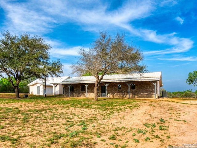 601 Wildflower Dr, Lytle, TX 78052 - rear view of house with metal roof