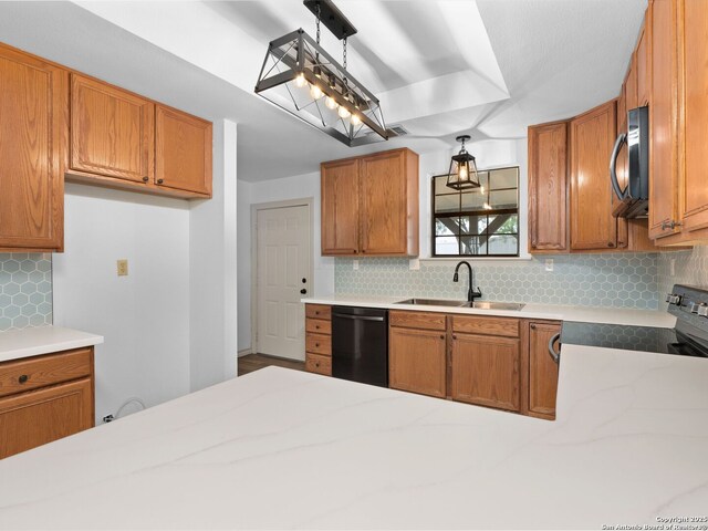 601 Wildflower Dr, Lytle, TX 78052 - kitchen with visible vents, a sink, brown cabinetry, black appliances, and decorative backsplash