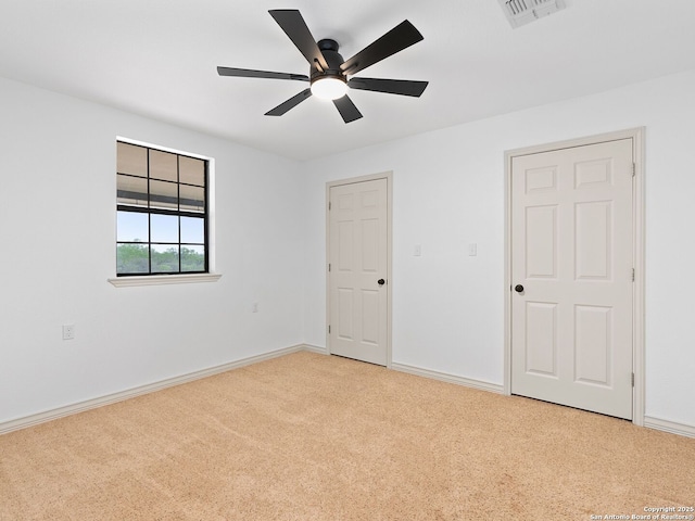 601 Wildflower Dr, Lytle, TX 78052 - unfurnished bedroom featuring carpet floors, baseboards, a ceiling fan, and visible vents