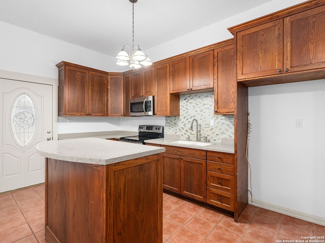 601 Wildflower Dr, Lytle, TX 78052 - kitchen featuring a notable chandelier, a sink, appliances with stainless steel finishes, backsplash, and light tile patterned flooring