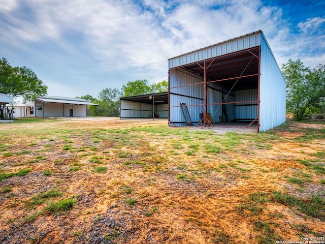 601 Wildflower Dr, Lytle, TX 78052 - view of pole building with a carport