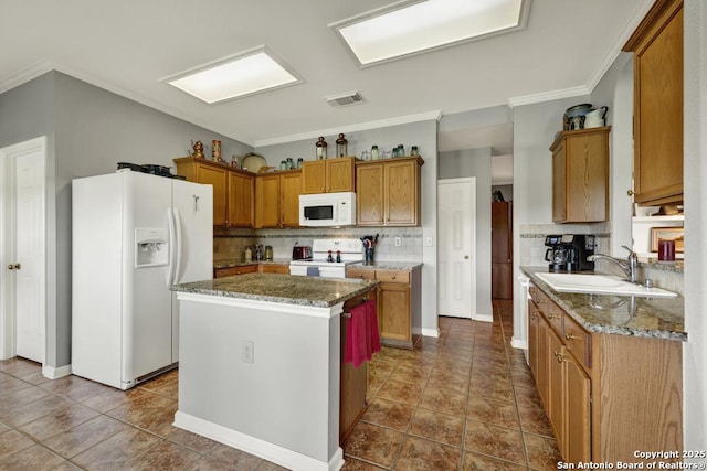 kitchen featuring tasteful backsplash, a sink, ornamental molding, white appliances, and a kitchen island
