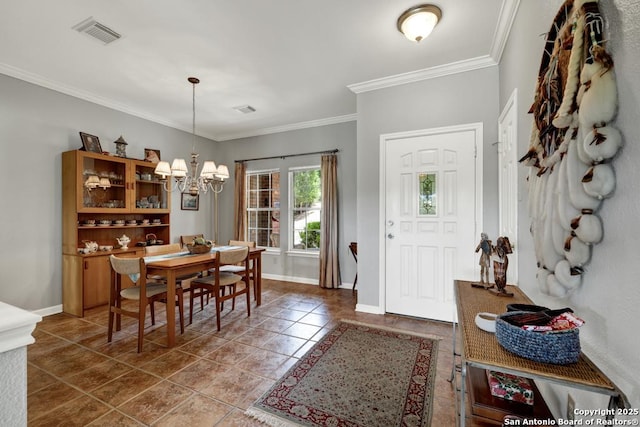 entryway featuring crown molding, visible vents, baseboards, and an inviting chandelier