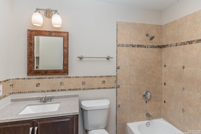 full bathroom with washtub / shower combination, vanity, tile walls, and toilet