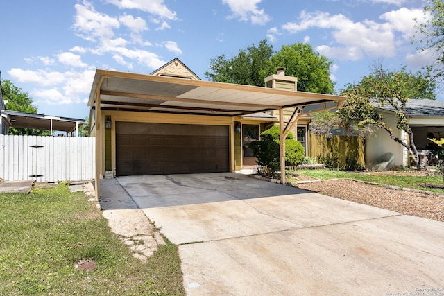 view of front of home featuring an attached garage, a chimney, driveway, and fence