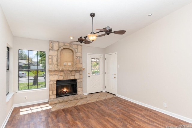 unfurnished living room with plenty of natural light, ceiling fan, and wood finished floors