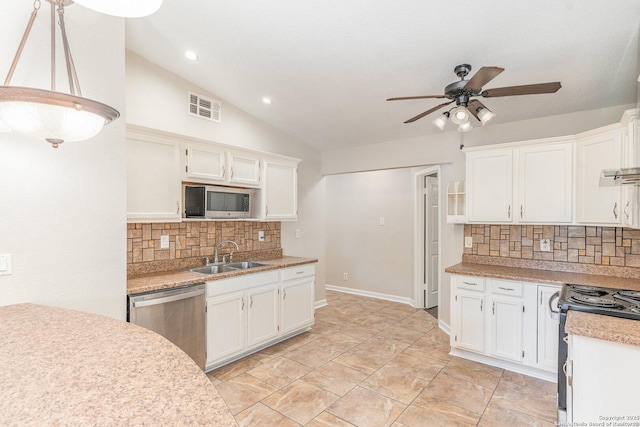 kitchen with appliances with stainless steel finishes, visible vents, decorative backsplash, a sink, and ceiling fan