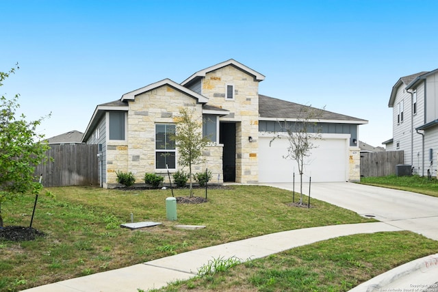 view of front of house with concrete driveway, a garage, fence, and stone siding