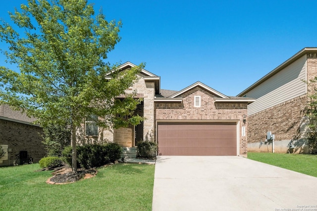 view of front facade featuring an attached garage, driveway, a front yard, and brick siding