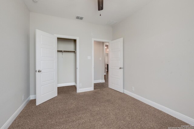 unfurnished bedroom with carpet, visible vents, a closet, and baseboards